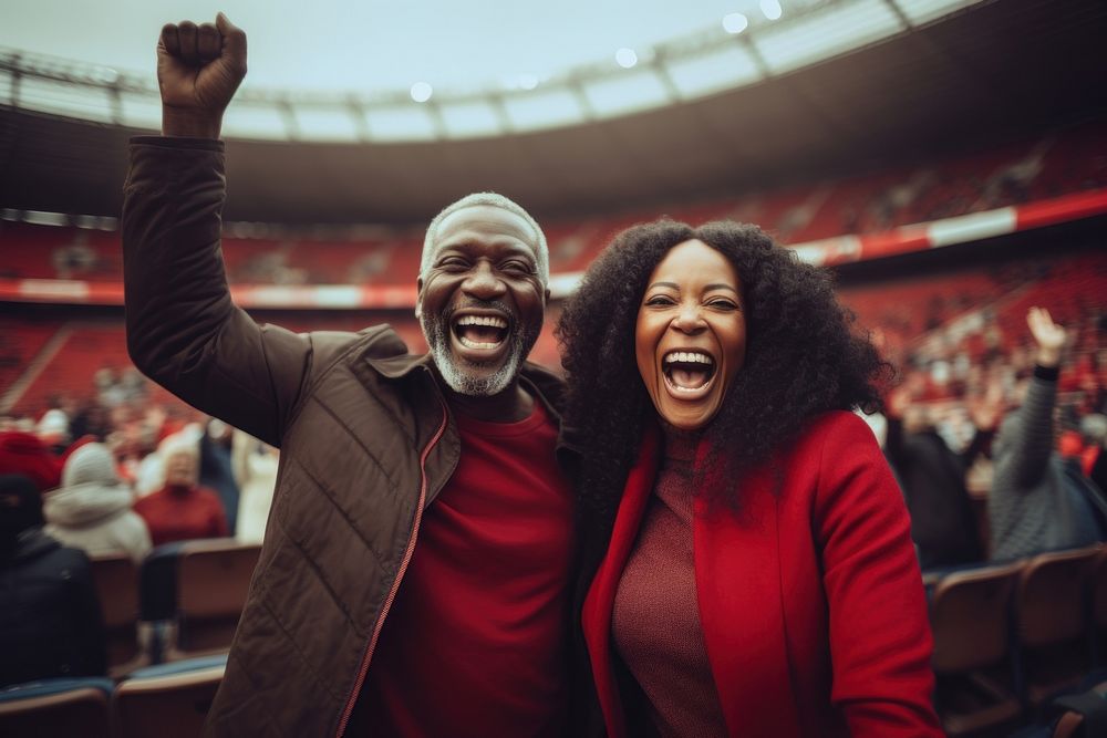 Black mature couple cheering sport game laughing stadium sports. AI generated Image by rawpixel.