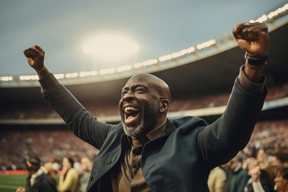 Black mature man cheering football game in stadium sports adult competition. AI generated Image by rawpixel.