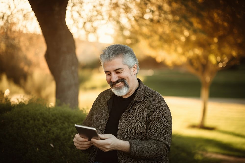 Middle age man playing handheld video game portrait adult photo. AI generated Image by rawpixel.