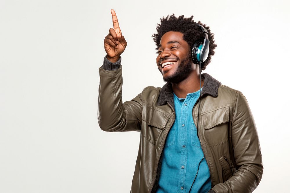 African american man enjoy music while finger pointing to sky laughing smile adult. AI generated Image by rawpixel.