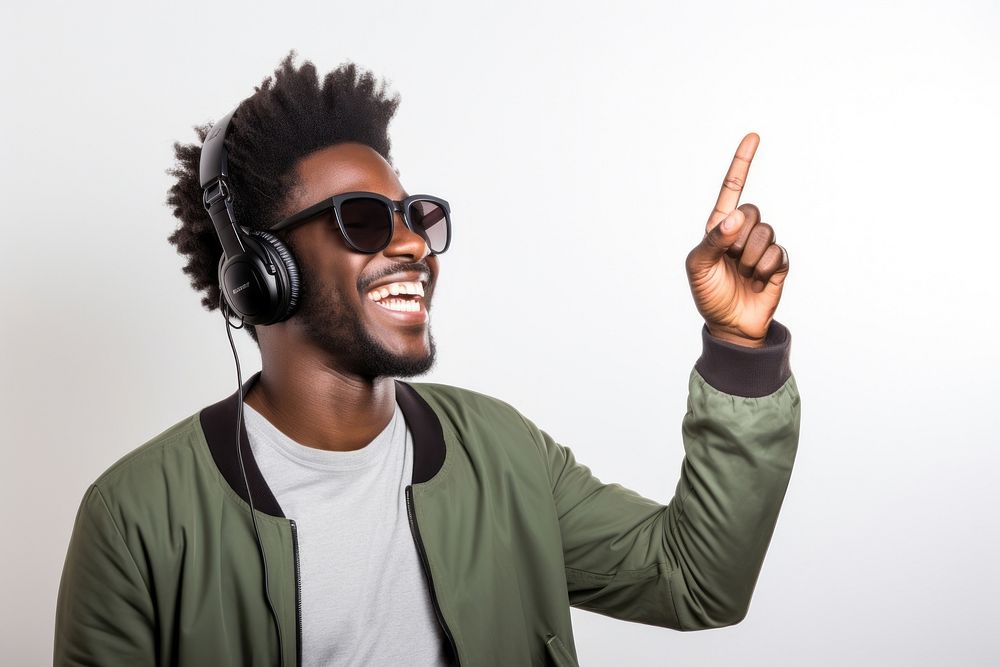 African american man enjoy music while finger pointing to sky headphones headset adult. AI generated Image by rawpixel.