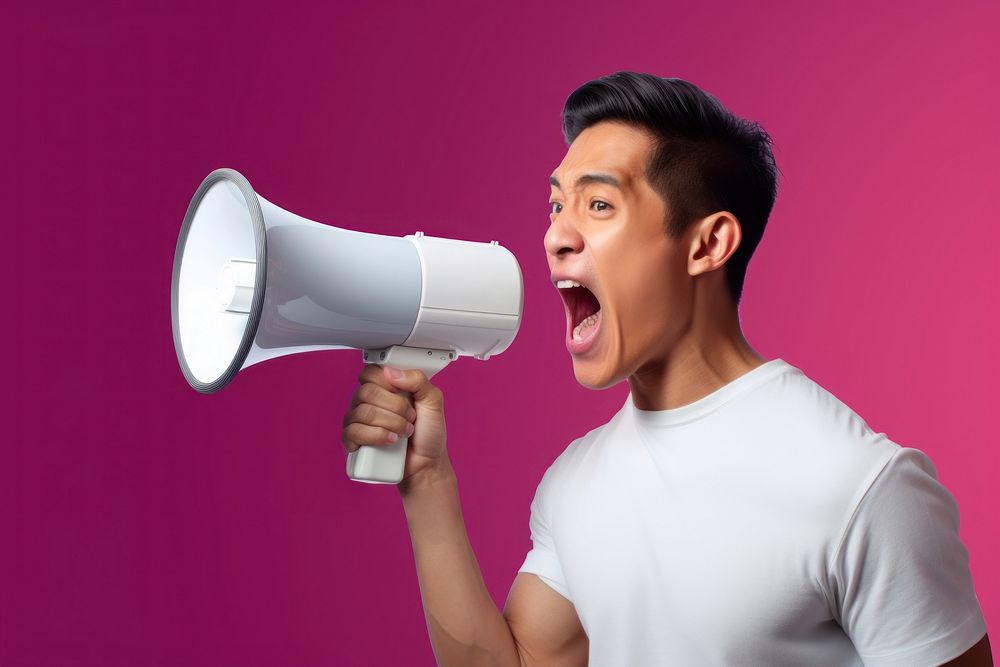Asian man using megaphone shouting technology happiness. AI generated Image by rawpixel.