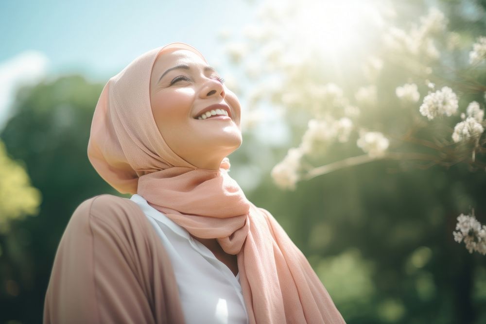 Happy senior hijab woman relaxing outdoors smile adult. AI generated Image by rawpixel.