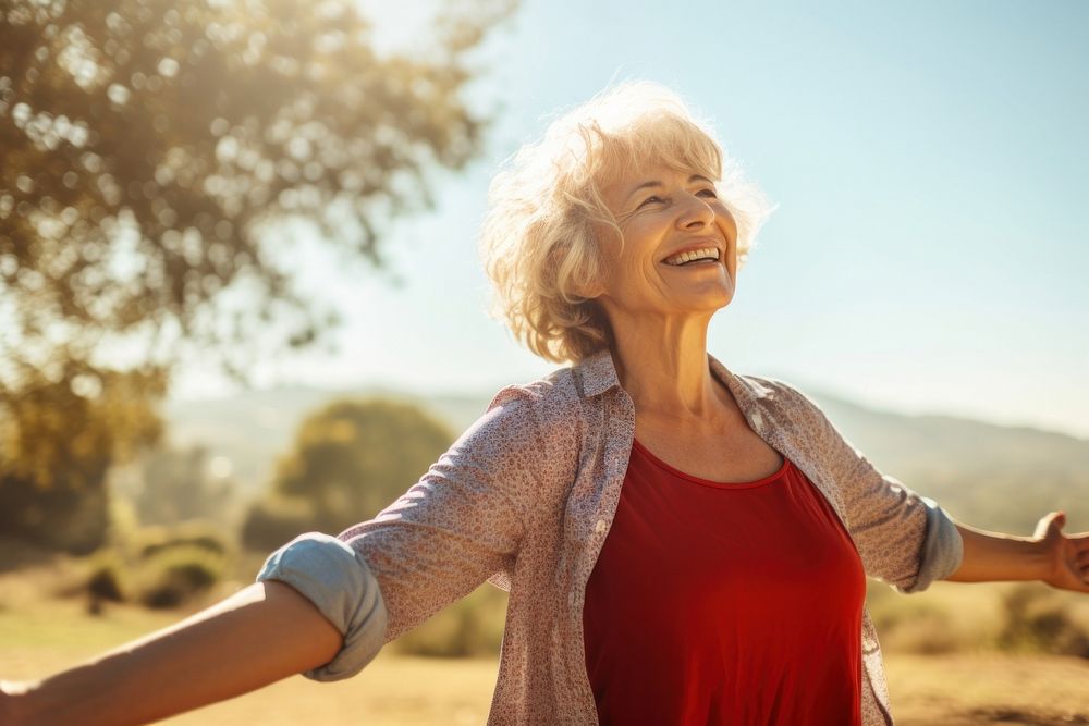 Happy senior woman stretching laughing outdoors adult. AI generated Image by rawpixel.