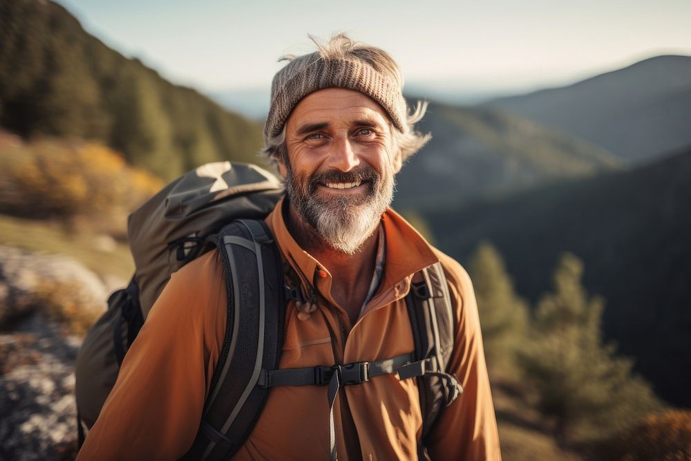 Warm-heart mature man on adventure trail in mountain backpacking outdoors hiking. 