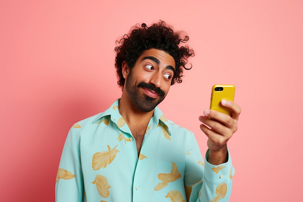 An 27 yo indian pointing at his phone photography happiness adult. AI generated Image by rawpixel.
