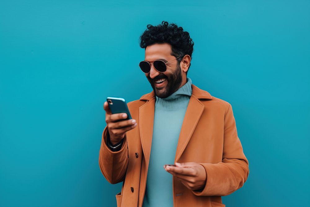 An 27 yo indian pointing at his phone happiness looking fashion. AI generated Image by rawpixel.