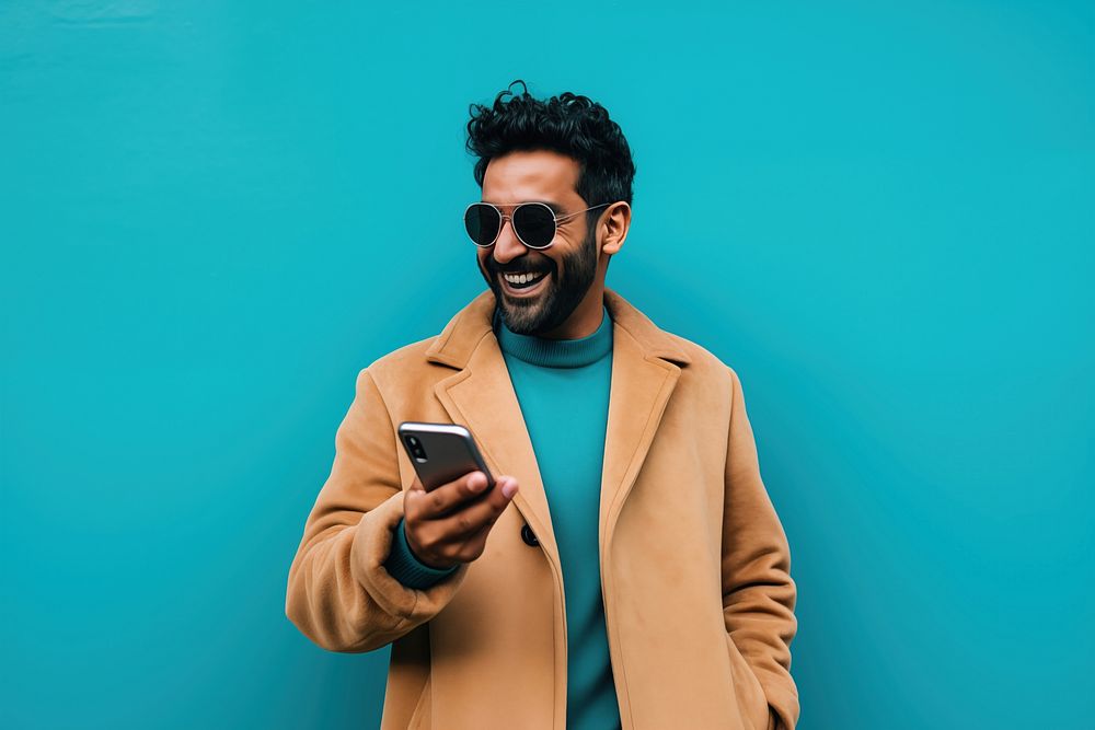 An 27 yo indian pointing at his phone photography happiness portrait. AI generated Image by rawpixel.