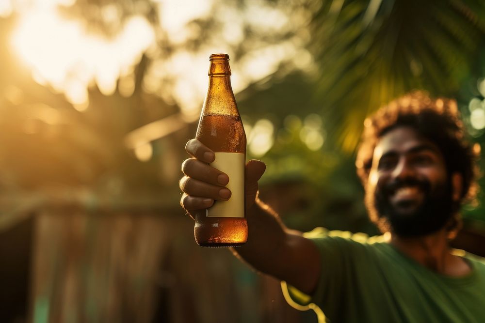 Indian man handing a bottle of beer drinking refreshment container. AI generated Image by rawpixel.