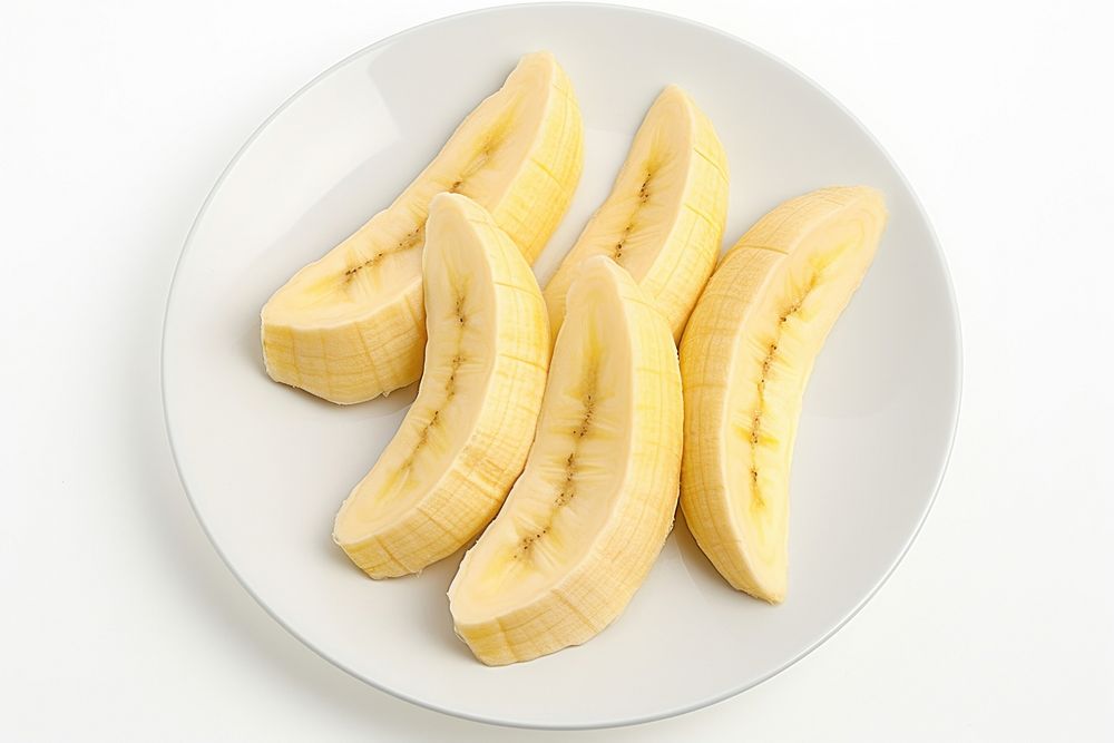 3 pieces of cut up banana on plate fruit plant food. AI generated Image by rawpixel.