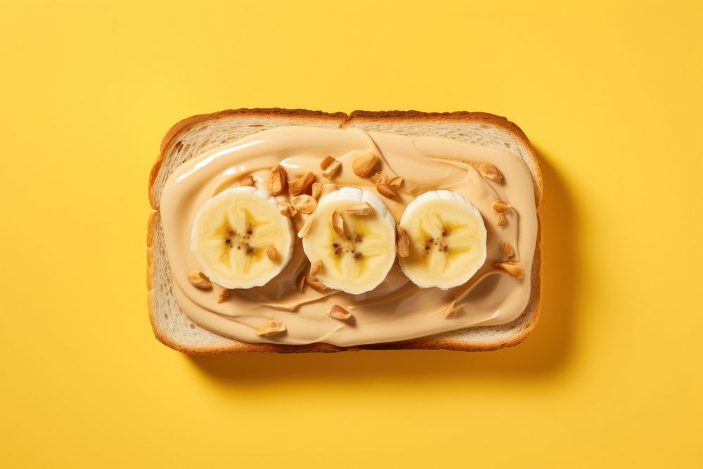 Sandwich with peanut butter and slice of bananas on top food breakfast freshness. 