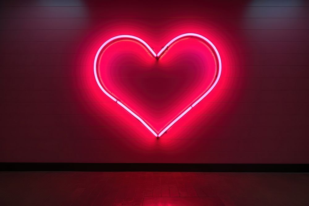Heart shaped neon sign on empty wall light illuminated darkness. AI generated Image by rawpixel.