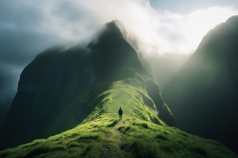 Man walking on the grassy mountain top landscape adventure outdoors. AI generated Image by rawpixel.