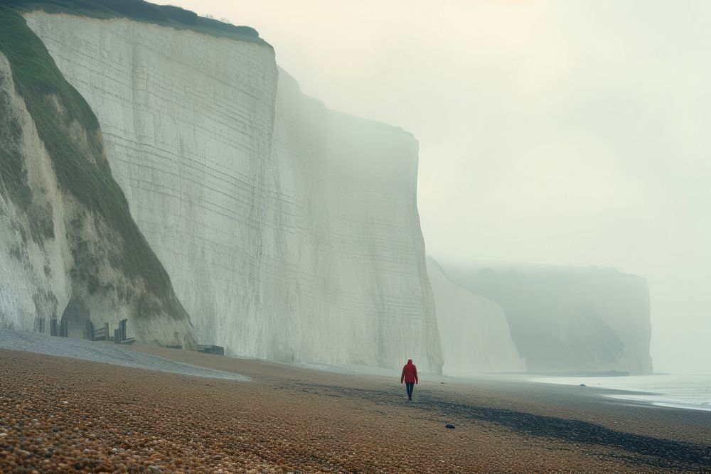 Man walking on a beach cliff cloud day. AI generated Image by rawpixel.