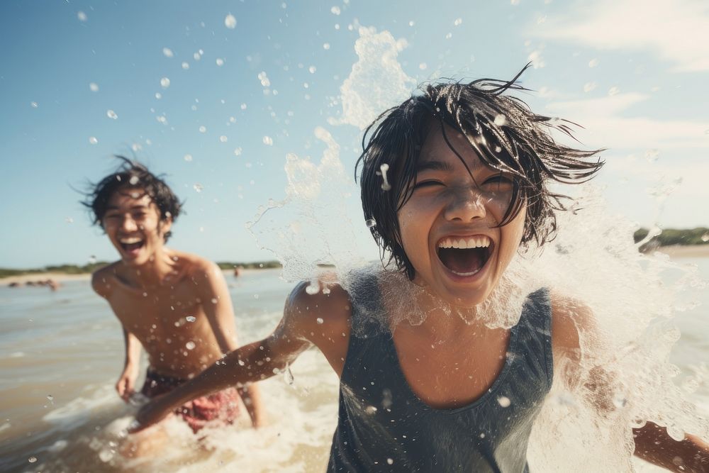Asian teenage friends summer beach splashing. AI generated Image by rawpixel.