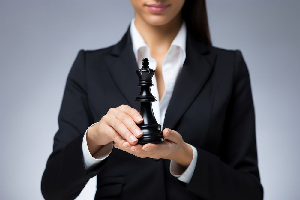 Businesswoman holding a chess piece chessboard recreation decisions. AI generated Image by rawpixel.
