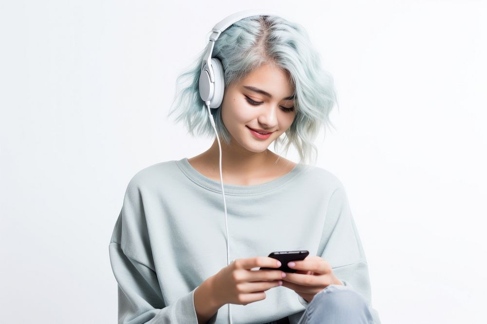 Teenage girl streaming online music on mobile phone headphones portrait adult. AI generated Image by rawpixel.