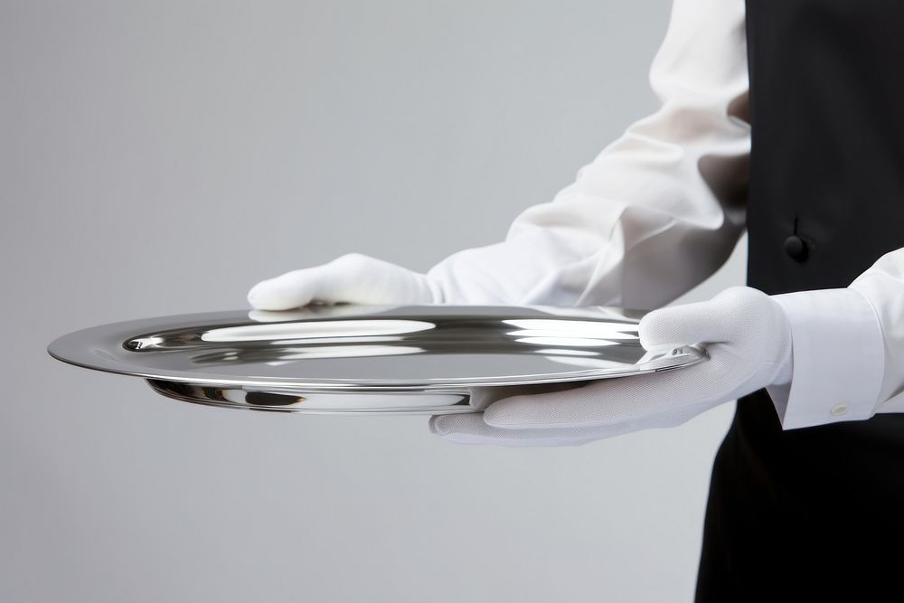 A man waitress hand is holding up a silver platter adult glove midsection. AI generated Image by rawpixel.