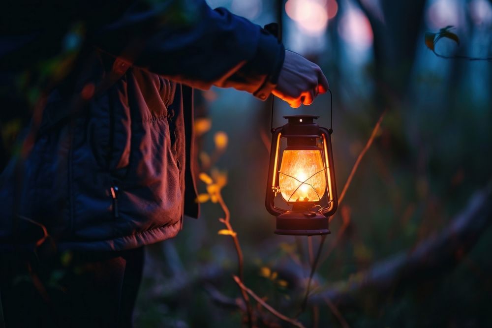 A man holding a lantern in the night outdoors nature illuminated. AI generated Image by rawpixel.