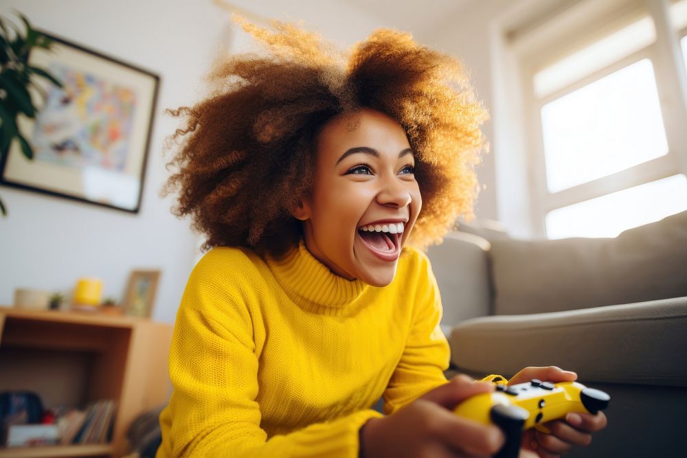 Girl in bright yellow sweater playing game laughing smile adult. AI generated Image by rawpixel.