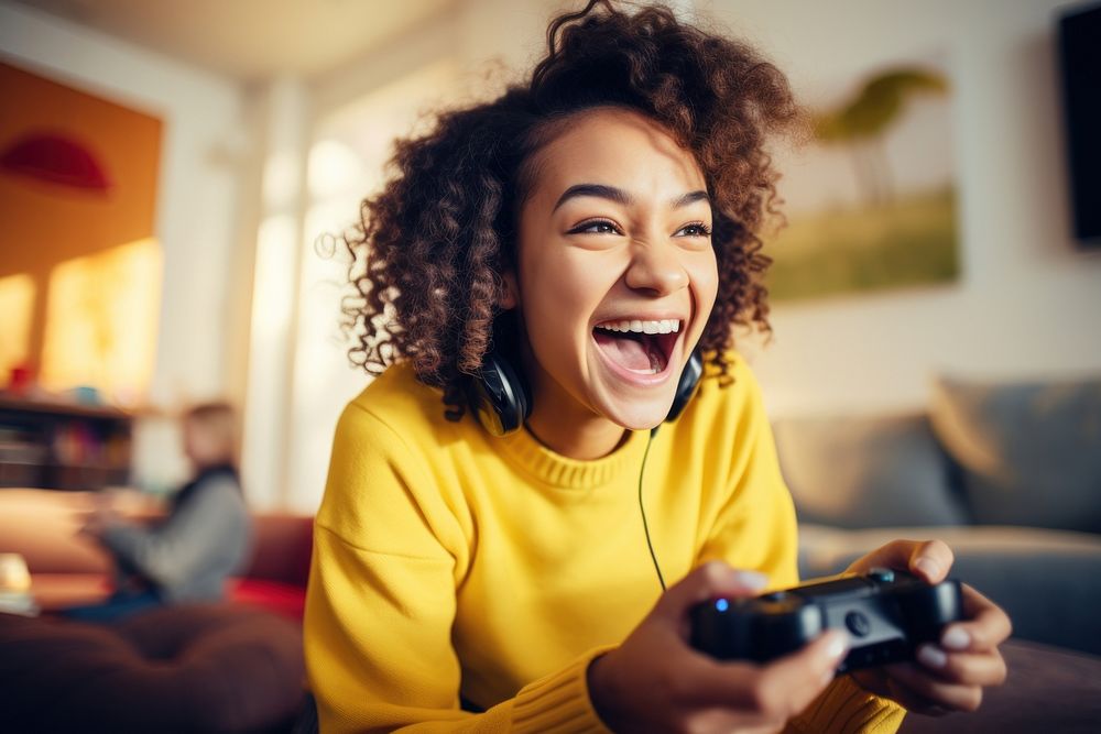Girl in bright yellow sweater playing game laughing adult joy. AI generated Image by rawpixel.