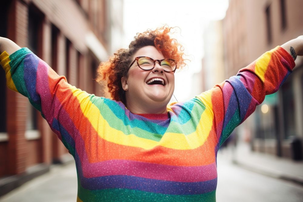 A chubby woman in a rainbow knit shirt laughing outdoors smiling. AI generated Image by rawpixel.