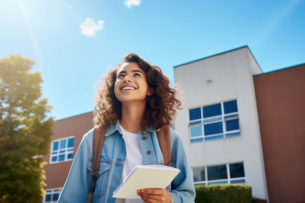 A Latinx girl high school student holding summer sky. AI generated Image by rawpixel.