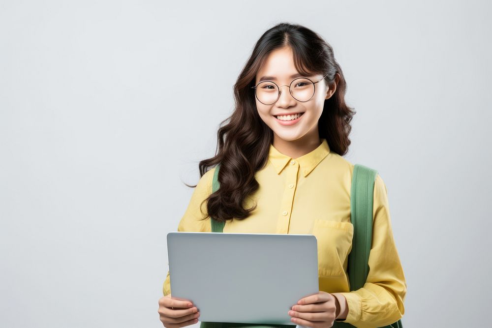 Portrait of smiling Asia teen girl glasses laptop computer. AI generated Image by rawpixel.