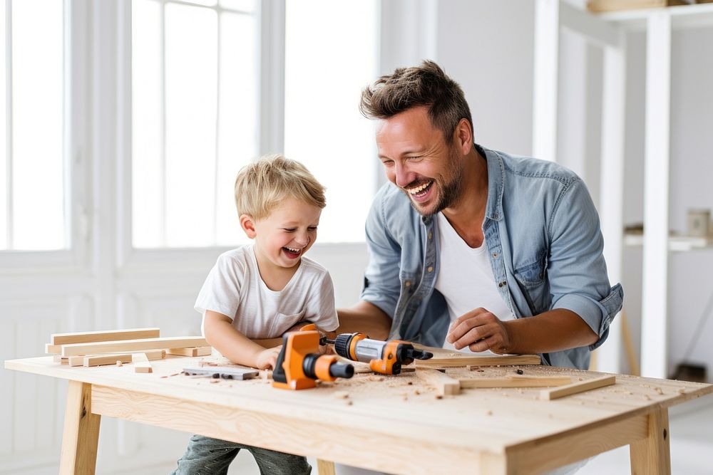 Father and son using hammer on a wooden desk together child togetherness construction. AI generated Image by rawpixel.