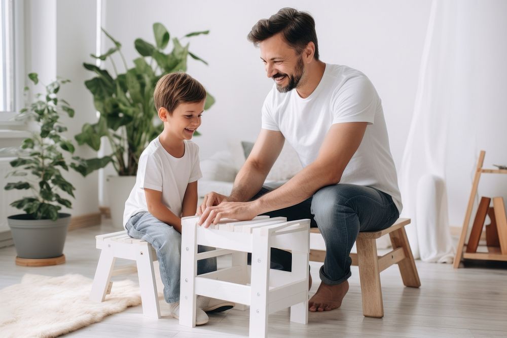 Father and son help paint wood chair together furniture sitting adult. AI generated Image by rawpixel.