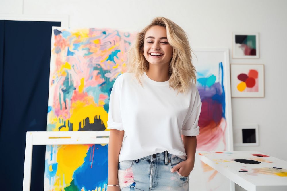 A teenage graphic designer in clean white t shirt painting laughing studio. AI generated Image by rawpixel.