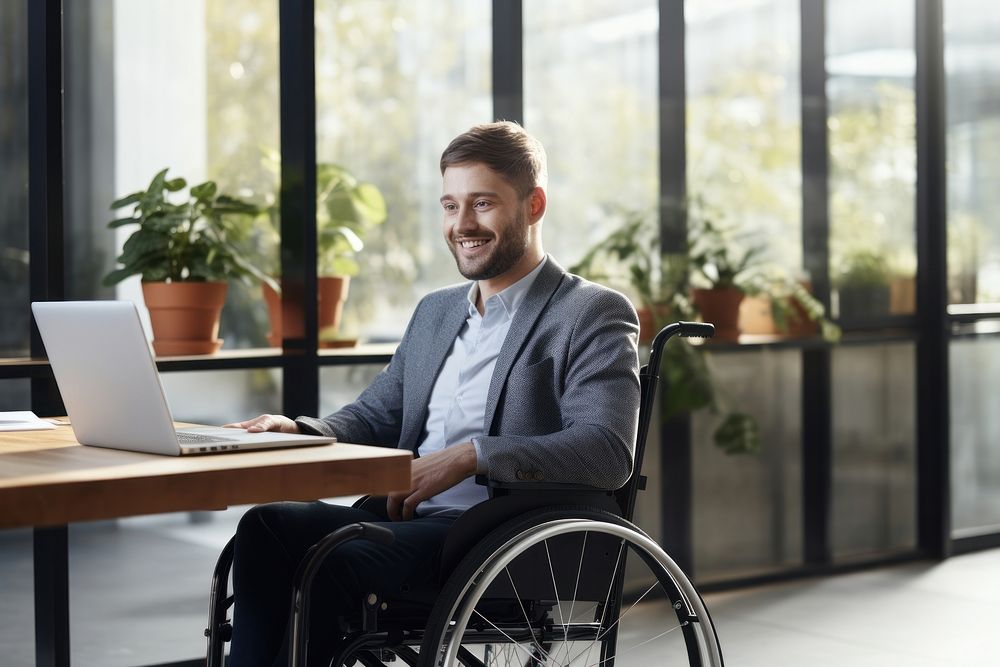 Male with disability wheelchair computer sitting. AI generated Image by rawpixel.