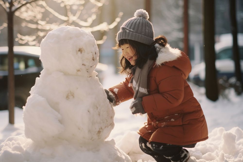 Asian children making a snowman outdoors winter nature. AI generated Image by rawpixel.