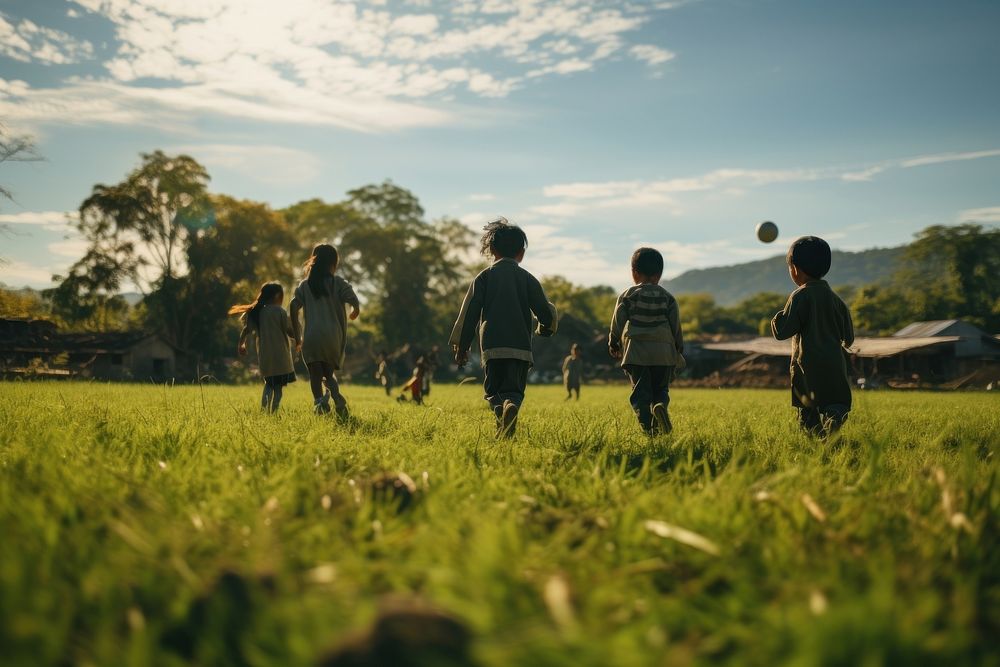 Thai children playing football countryside outdoors nature. AI generated Image by rawpixel.