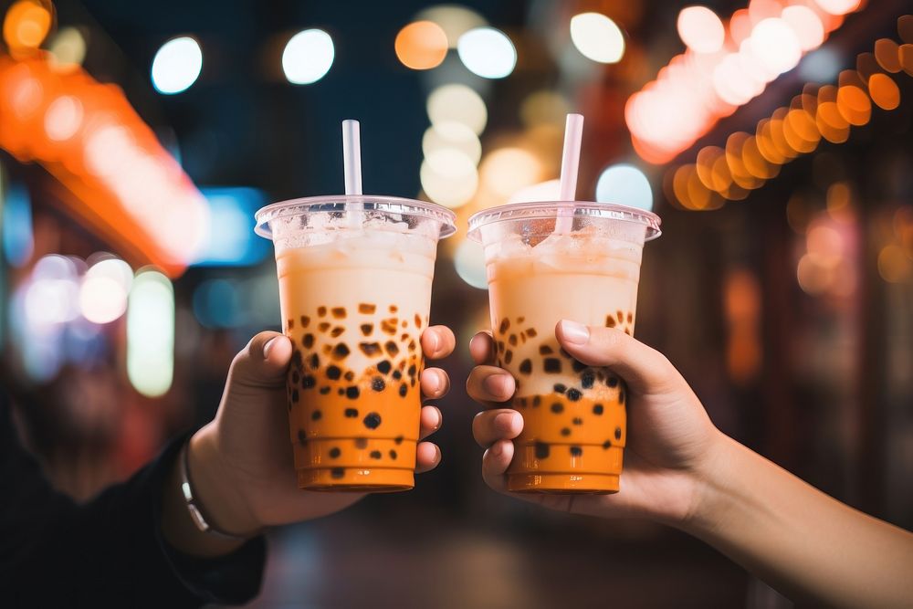 Bubble milk tea holding drink night. AI generated Image by rawpixel.