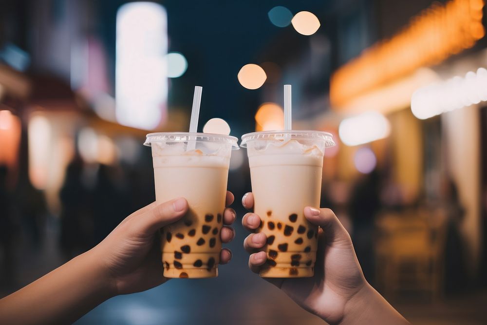 Bubble milk tea holding drink night. AI generated Image by rawpixel.