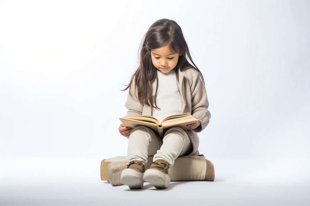 Asian girl reading book sitting child cross-legged. AI generated Image by rawpixel.