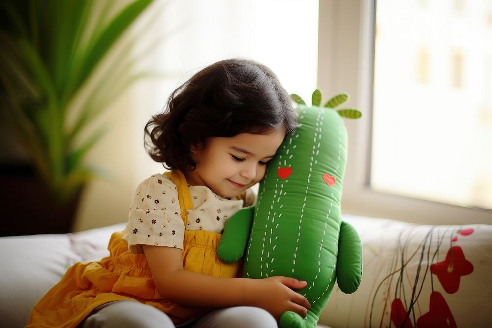 Baby hugging a cactus fabric toy furniture portrait sitting. AI generated Image by rawpixel.