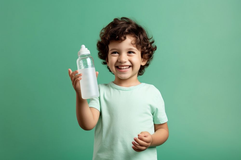 Kid holding bottle smile green. AI generated Image by rawpixel.