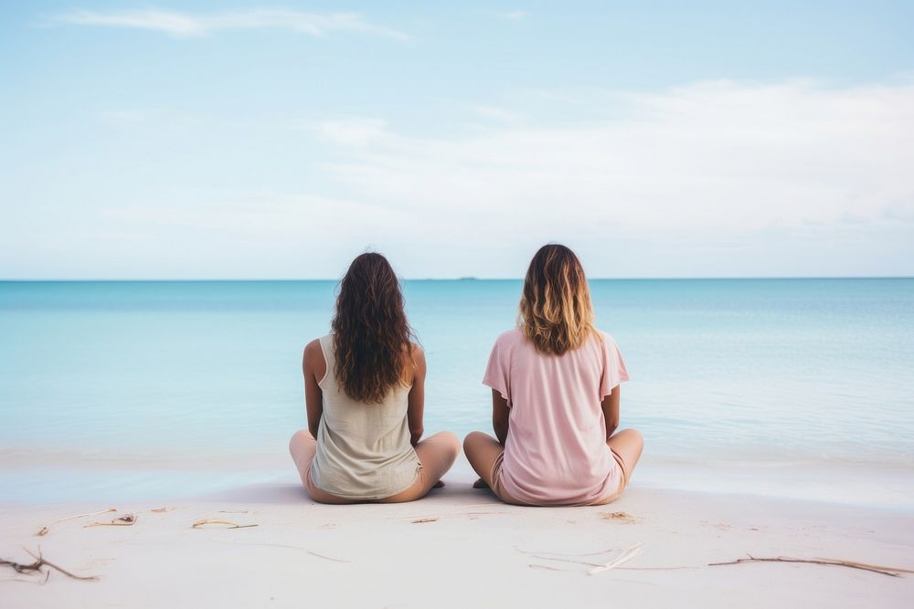 Female friends sitting in a lotus pose meditating outdoors vacation. AI generated Image by rawpixel.