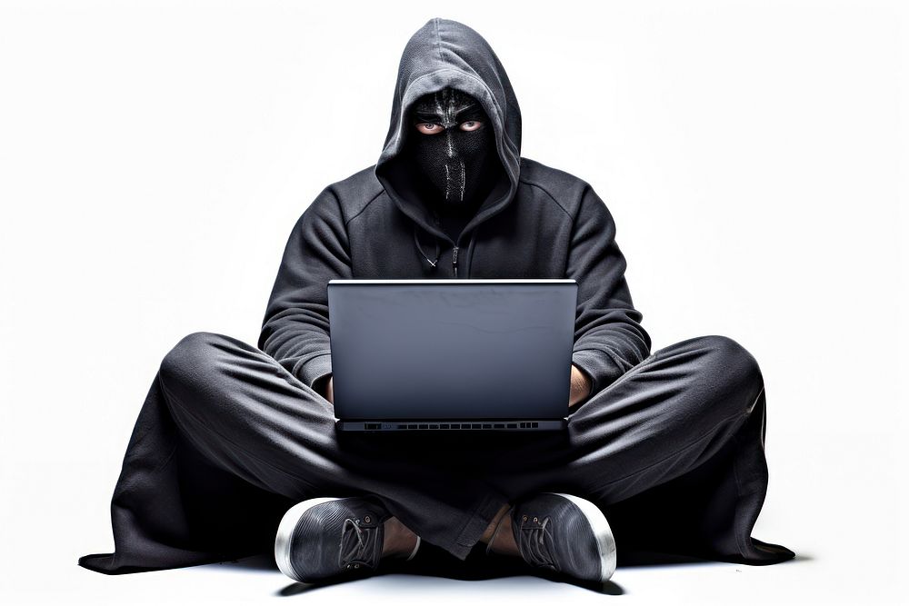 Anonymous young man hacker in hood sitting playing laptop computer portrait electronics. AI generated Image by rawpixel.