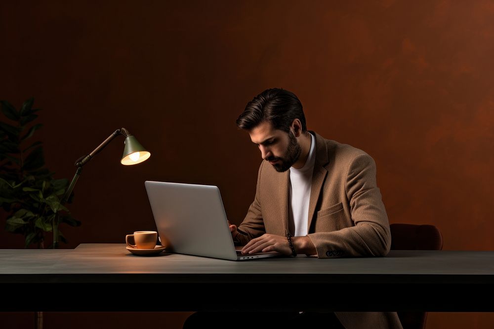 Man working on his laptop in the office computer sitting adult. AI generated Image by rawpixel.