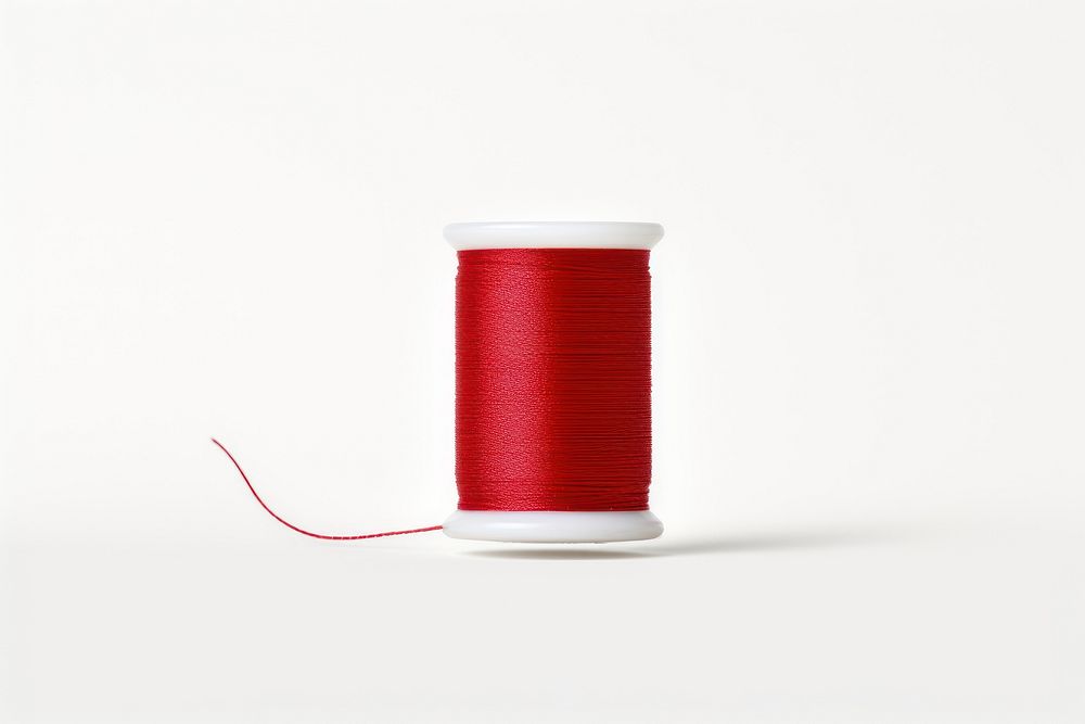 A spool thread with a needle in it white background technology material. AI generated Image by rawpixel.