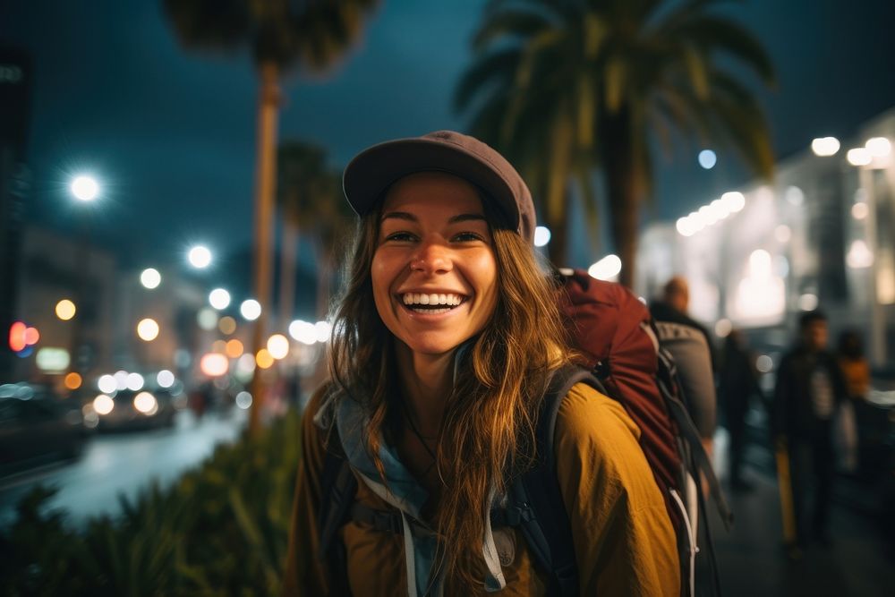 A Latina Brazilian female backpacker joyfully exploring Los Angeles during the nighttime nature laughing outdoors. AI…