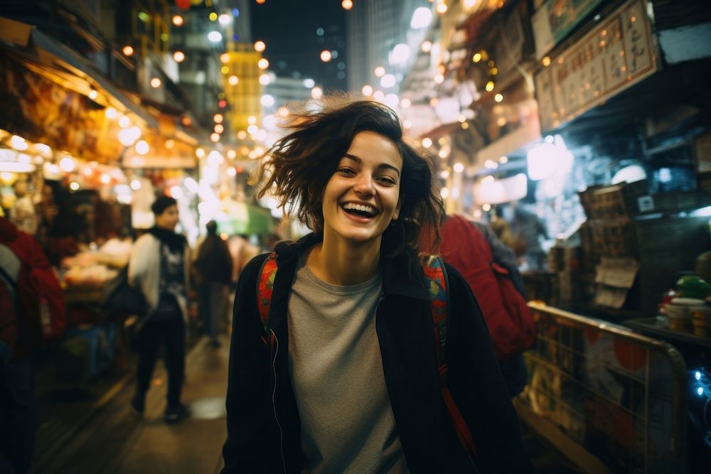 A Latina Brazilian female backpacker having fun exploring the night markets in Hong Kong portrait laughing street. AI…