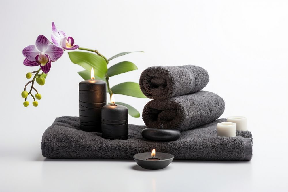 Spa concept with zen basalt stones and towels candle flower plant. AI generated Image by rawpixel.