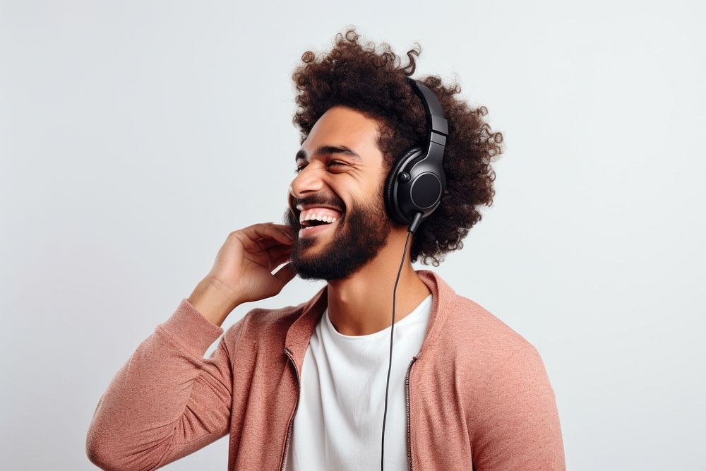 Happy young man headphones listening laughing. AI generated Image by rawpixel.