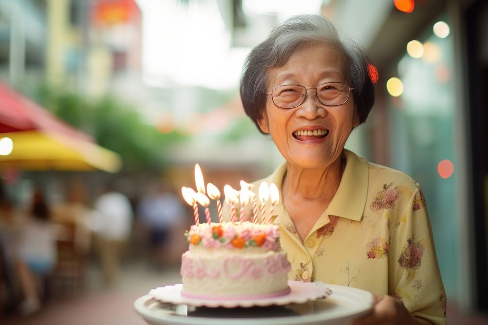 Elder Singaporean woman party cake birthday. AI generated Image by rawpixel.