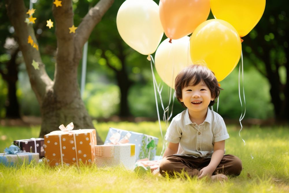 Japanese cute boy balloon birthday sitting. AI generated Image by rawpixel.