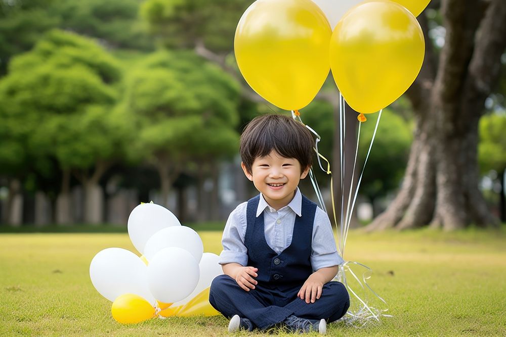 Japanese cute boy sitting balloon birthday. AI generated Image by rawpixel.